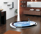 A round Jacuzzi bathtub offers the ultimate relaxation experience